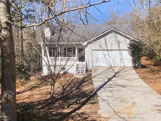 single story home featuring covered porch, driveway, and a garage