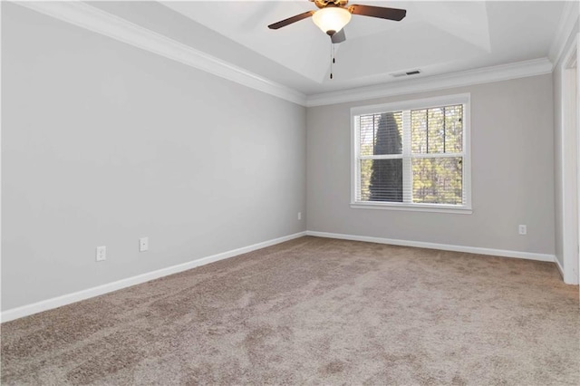 unfurnished room with crown molding, carpet, ceiling fan, and a tray ceiling