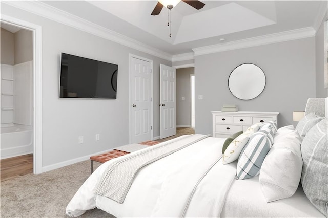 bedroom featuring light carpet, ornamental molding, a raised ceiling, and ceiling fan