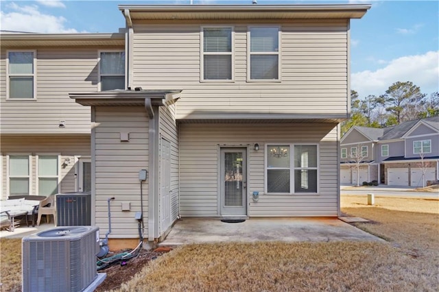 rear view of property featuring a patio and central air condition unit