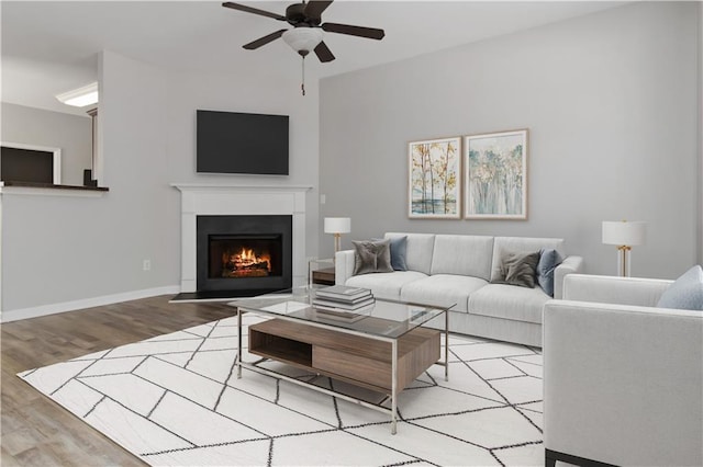 living room featuring ceiling fan and light hardwood / wood-style floors