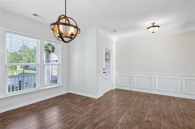 unfurnished dining area featuring a chandelier, dark wood-style flooring, ornamental molding, and visible vents
