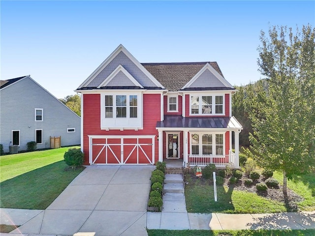 view of front of house featuring an outbuilding, an attached garage, a front lawn, a barn, and driveway