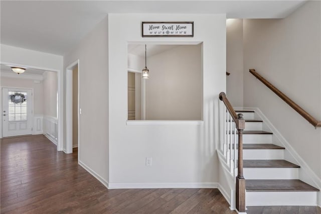 stairs featuring wood finished floors and baseboards