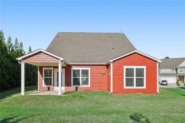 rear view of property with a yard
