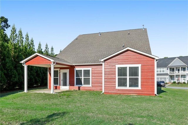 back of house featuring a yard and a patio area