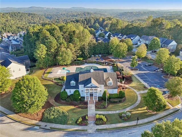 birds eye view of property with a residential view and a forest view