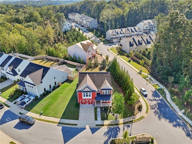 aerial view featuring a wooded view and a residential view
