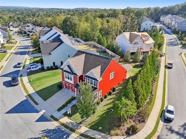 birds eye view of property featuring a wooded view and a residential view