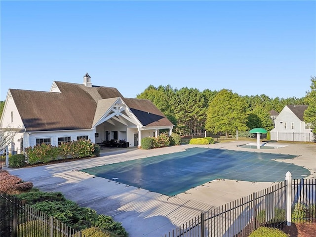 community pool featuring a patio area and fence