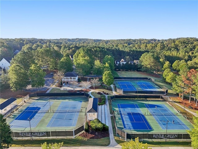birds eye view of property featuring a forest view