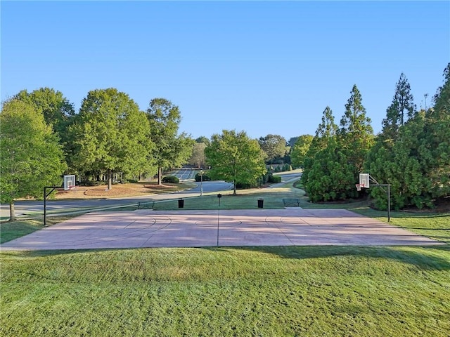 exterior space featuring community basketball court and a yard