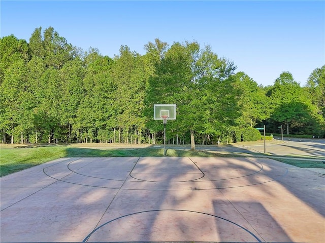 view of basketball court with community basketball court and a lawn