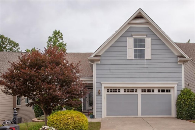 traditional-style home with an attached garage and concrete driveway