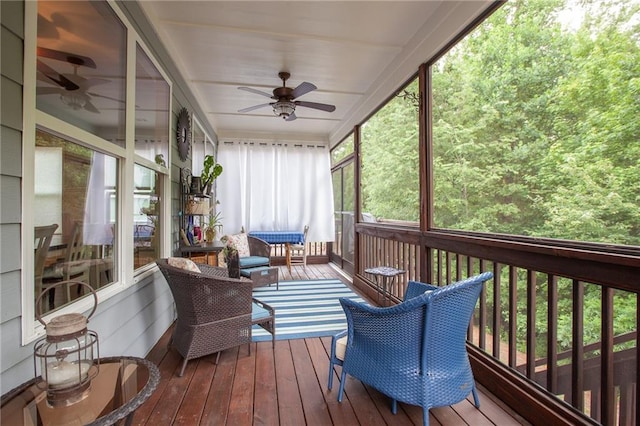 sunroom / solarium featuring ceiling fan