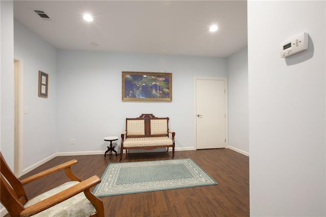 living area with recessed lighting, visible vents, baseboards, and wood finished floors