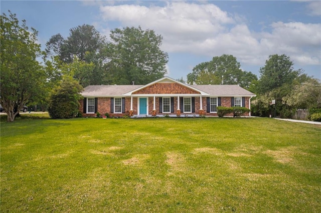 ranch-style home with a front yard and brick siding