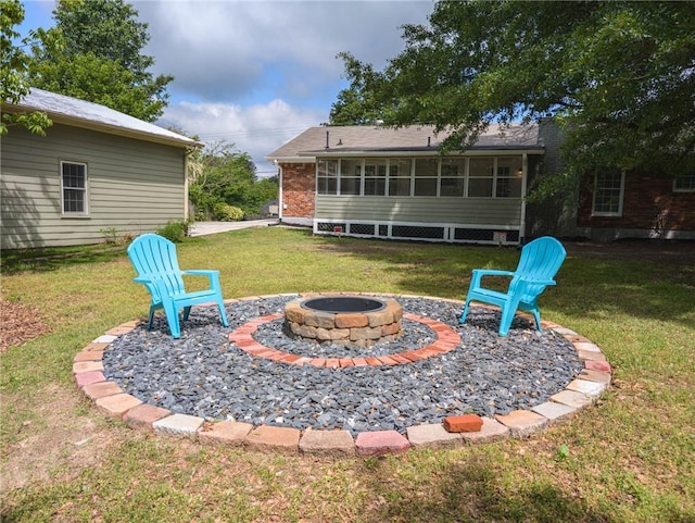 view of green lawn with a fire pit