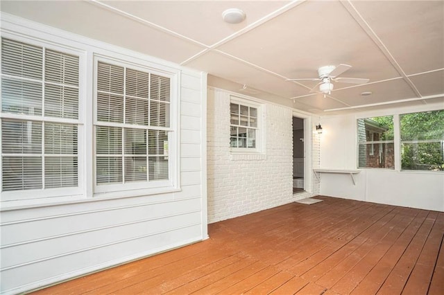 wooden terrace featuring a ceiling fan