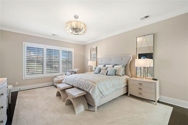 bedroom featuring hardwood / wood-style flooring and crown molding