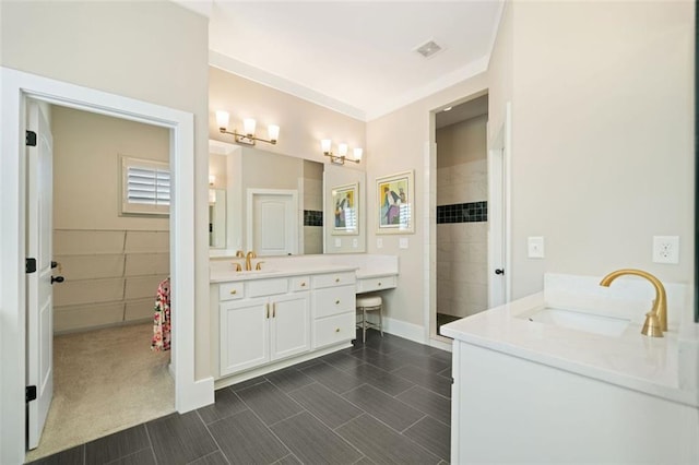 bathroom featuring a tile shower and vanity