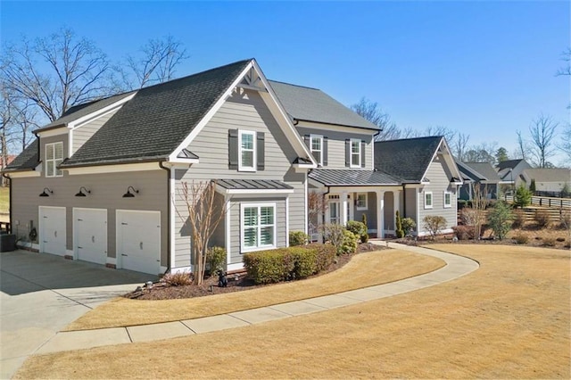 view of front of home with concrete driveway, central AC, metal roof, and a standing seam roof