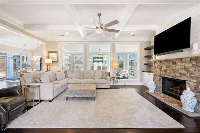 living room featuring ceiling fan, coffered ceiling, a fireplace, beamed ceiling, and dark hardwood / wood-style floors