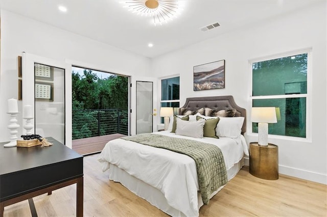 bedroom with access to outside and light hardwood / wood-style floors