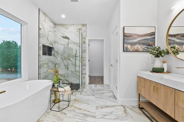 bathroom with vanity and independent shower and bath