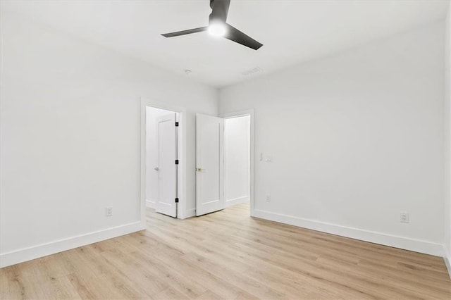 unfurnished room with ceiling fan and light wood-type flooring