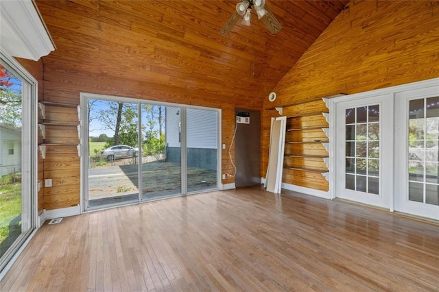 unfurnished sunroom with vaulted ceiling, a healthy amount of sunlight, ceiling fan, and wood ceiling