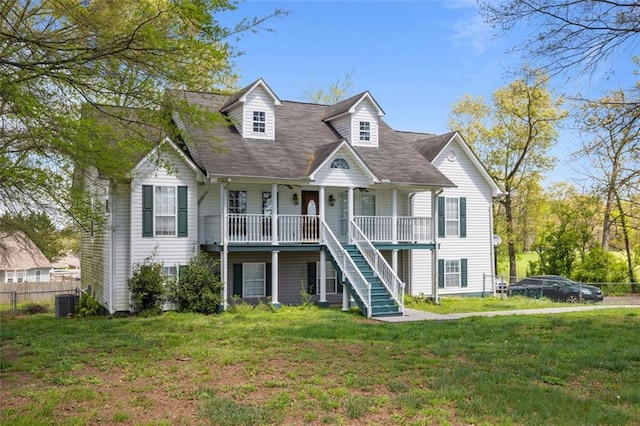 new england style home with a porch and a front lawn