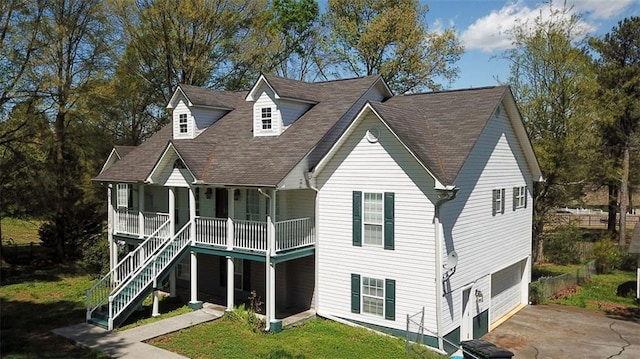 view of front of house with a garage, a porch, and a front yard