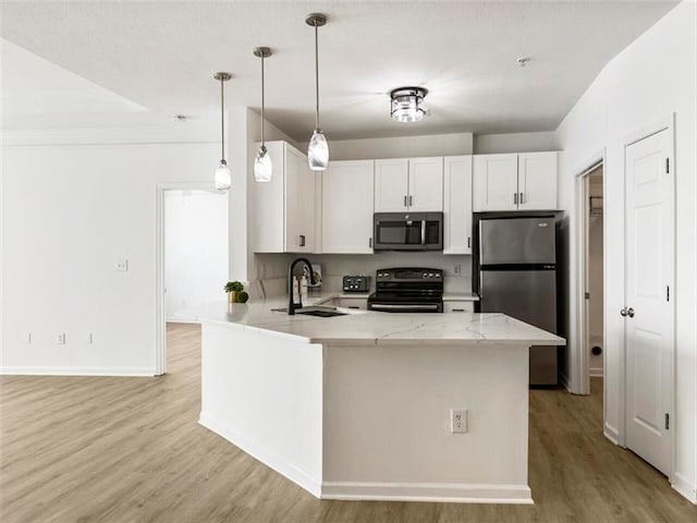 kitchen with kitchen peninsula, stainless steel appliances, sink, white cabinetry, and hanging light fixtures