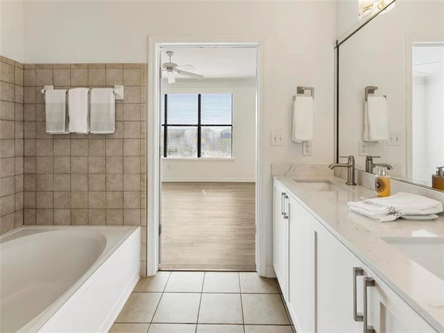 bathroom with tile patterned flooring, vanity, ceiling fan, and a bath