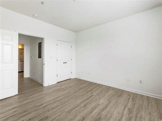 unfurnished bedroom featuring hardwood / wood-style floors and a closet