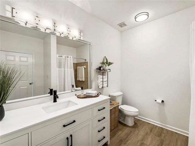 bathroom featuring vanity, a shower with shower curtain, wood-type flooring, and toilet