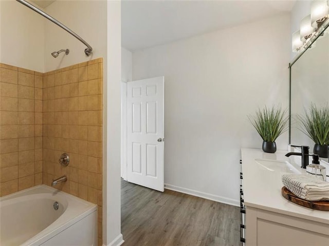 bathroom featuring vanity, hardwood / wood-style flooring, and tiled shower / bath combo