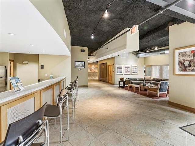 interior space with rail lighting and stainless steel refrigerator