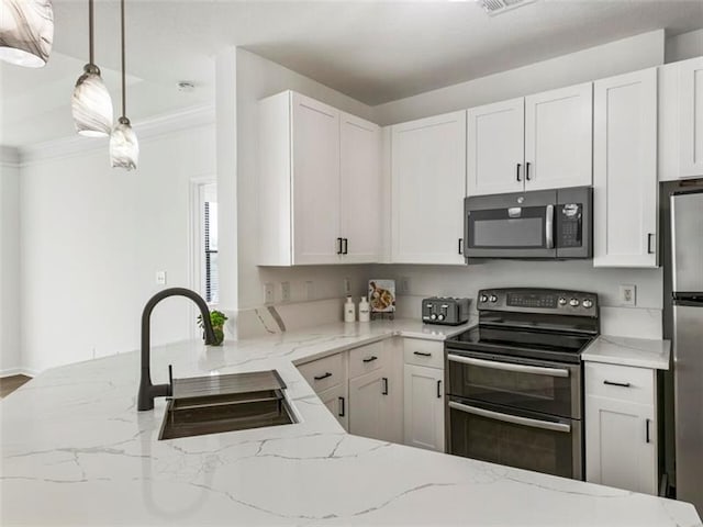 kitchen with light stone countertops, stainless steel appliances, sink, decorative light fixtures, and white cabinets