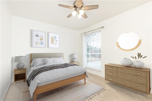 bedroom featuring ceiling fan and light carpet