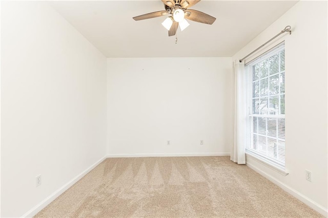 empty room featuring light carpet and ceiling fan