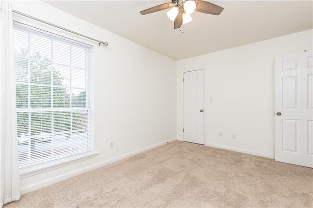 empty room with light carpet and ceiling fan