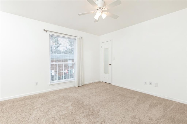 spare room with light carpet and ceiling fan