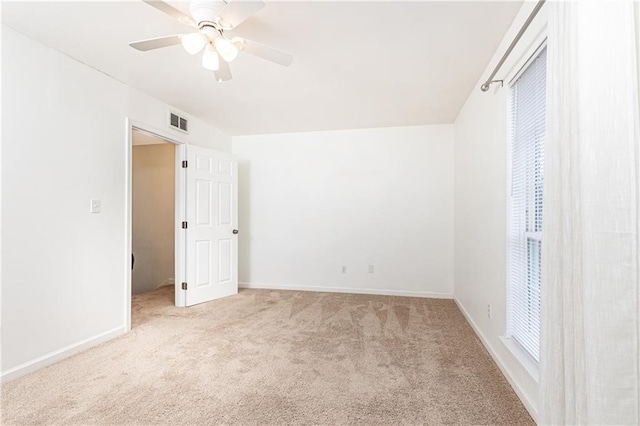 spare room with light carpet and ceiling fan