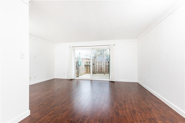 empty room with dark wood-type flooring and crown molding