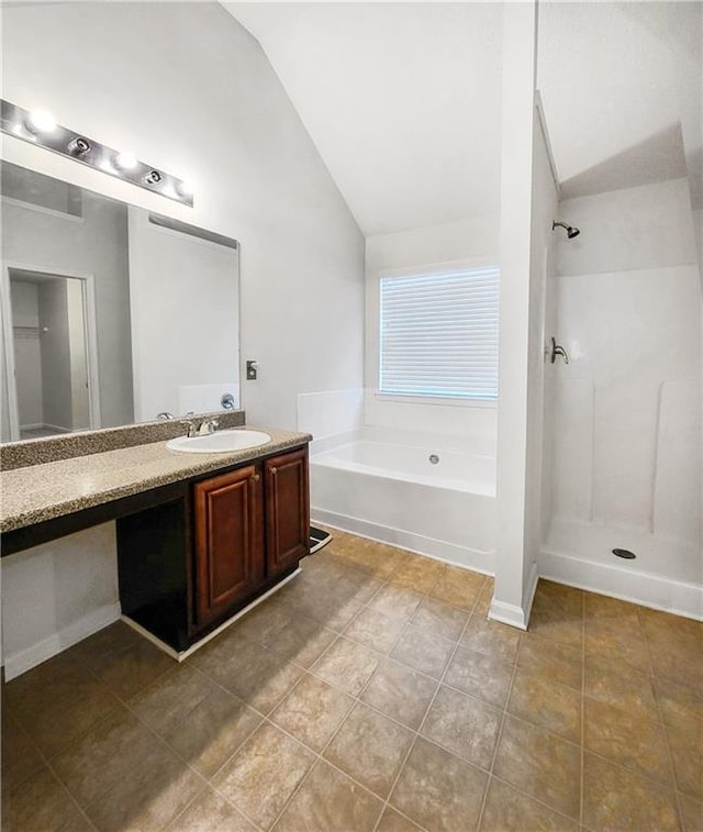 bathroom with vanity, vaulted ceiling, a shower, a bath, and tile patterned floors