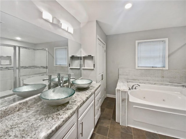 bathroom with tile patterned floors, vanity, and plus walk in shower