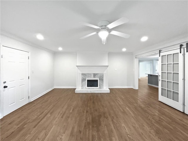2122 Belhaven Ln SE, Atlanta, GA 30315 - unfurnished living room featuring recessed lighting, a barn door, baseboards, ceiling fan, and wood finished floors