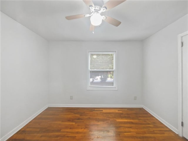 unfurnished room featuring dark wood-type flooring and ceiling fan